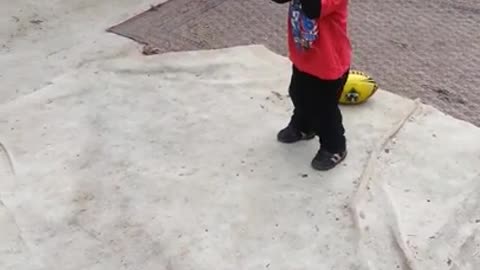 Siblings bump heads yellow football