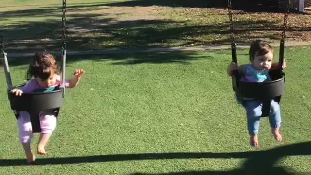 Mika and Zoey on a swing at Commons Park
