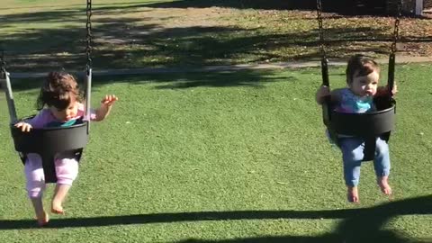 Mika and Zoey on a swing at Commons Park