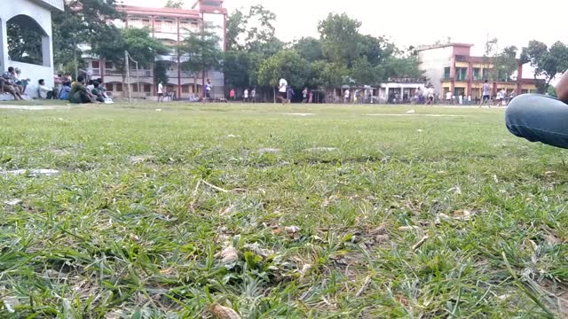 A part of football match of a village playground.It is really very interesting.