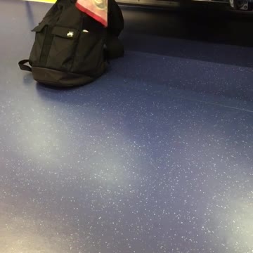 Man on train cleaning feet with red towel