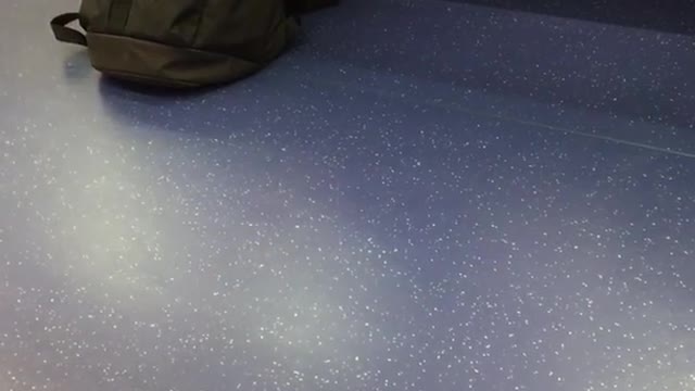 Man on train cleaning feet with red towel