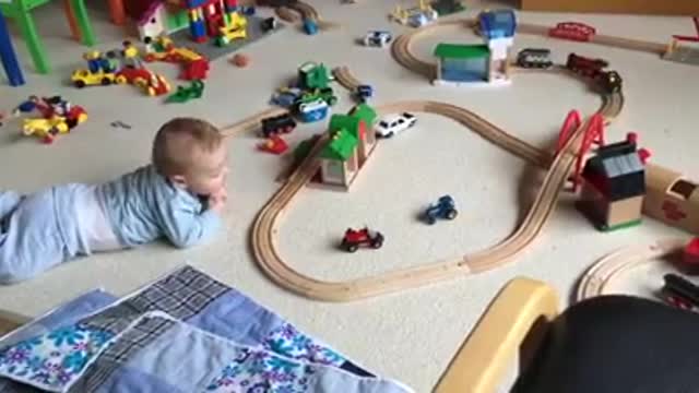 Cute baby watching his train move