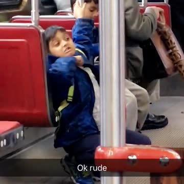 Kid in blue jacket signals cutting throat