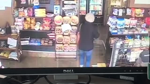 Security camera, woman walks inside convenience store, trips on floor and falls