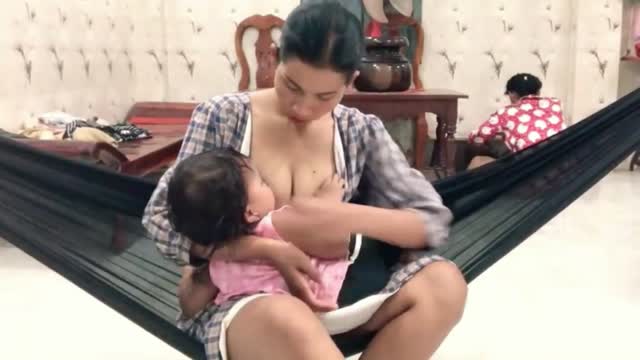 Nice baby breastfeeding milk from mom cute lady