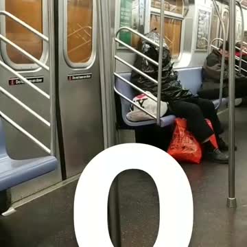 Q man sleeps inside trash bag on subway