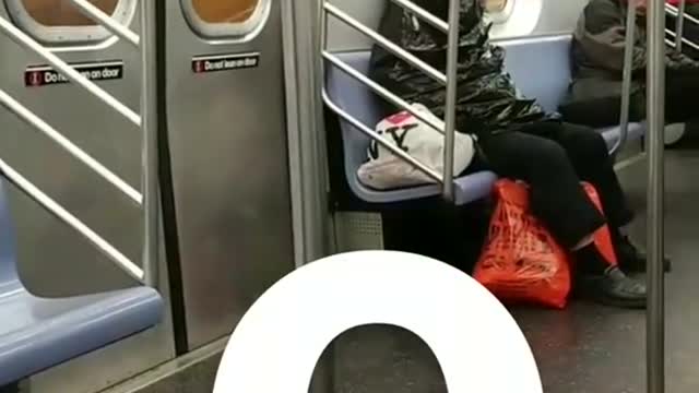 Q man sleeps inside trash bag on subway