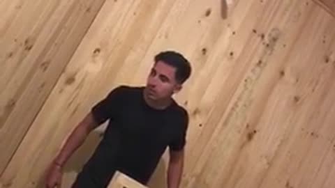 Man takes off shirt, climbs bed and falls