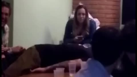 Guy uses his head to knock down cans of beer