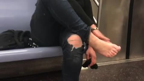 Old woman touching bare feet 