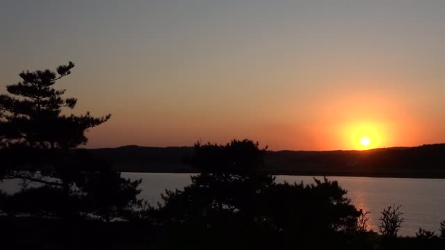 Red sunset, mountains and river trees. 2