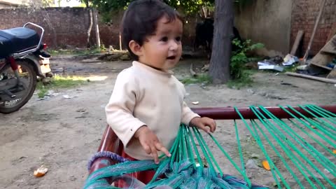 Cute baby wants to eat orange
