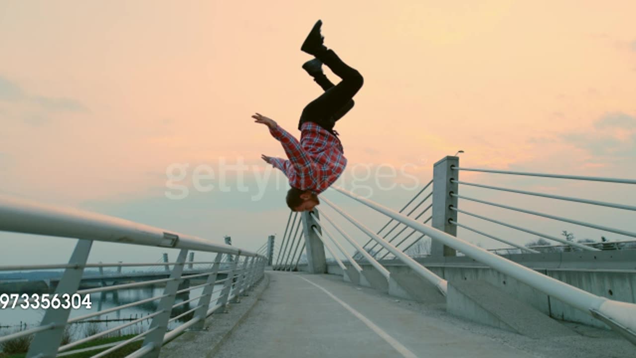 SLO MO B-boy performing a somersault from a fence