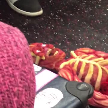 Weird unskinned doll on subway train floor