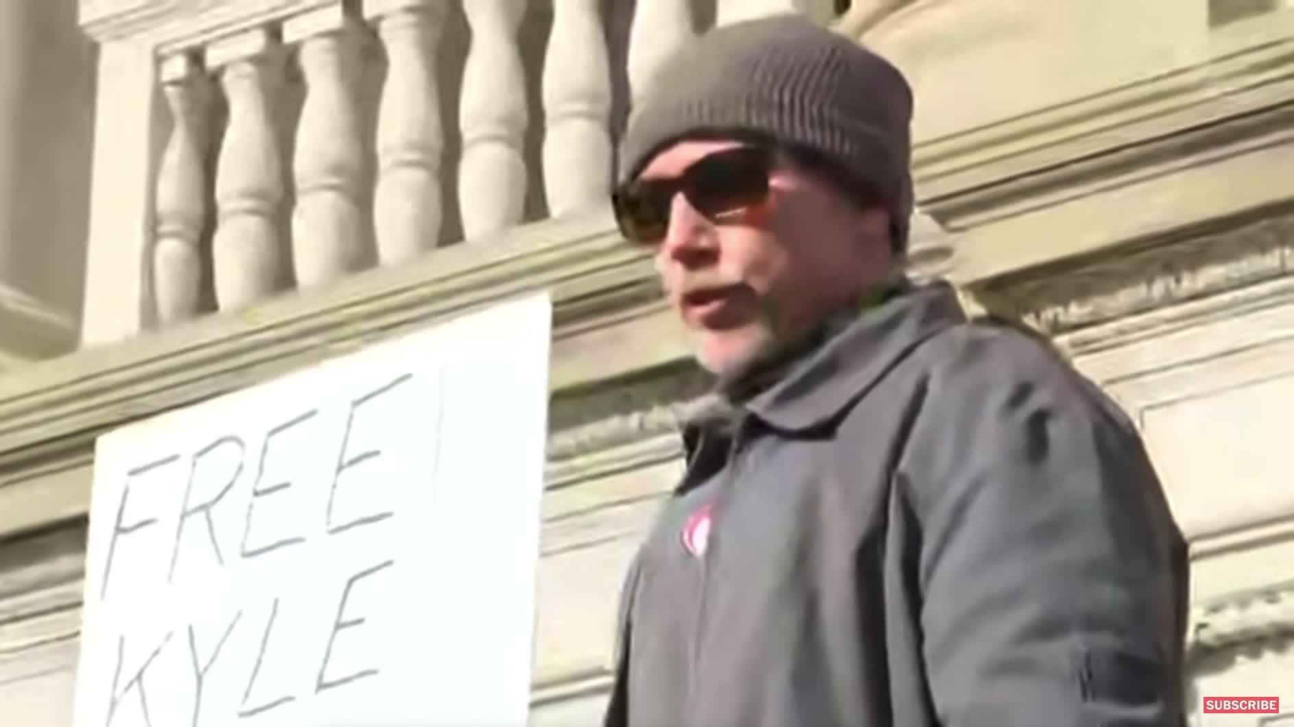 A man trolls reporters outside of the Kenosha courthouse by saying his name is "Brandon, Let's Go"