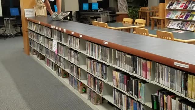 Guy uses library as skatepark
