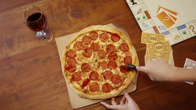 Slicing A Pizza With The Use Of A Pizza Cutter
