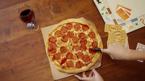 Slicing A Pizza With The Use Of A Pizza Cutter