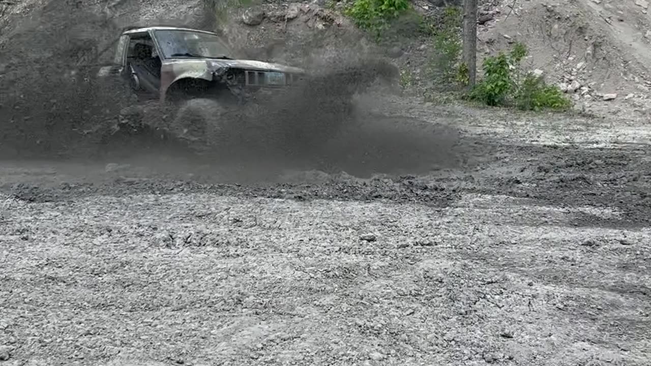 Boy blasting through the mud, having a blast!