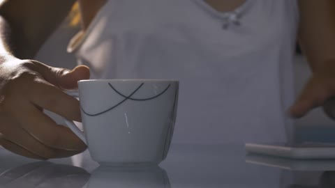 Cup with hot morning coffee in the foreground