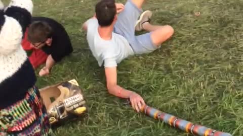 Guys on top of friends shoulders running towards one another one falls