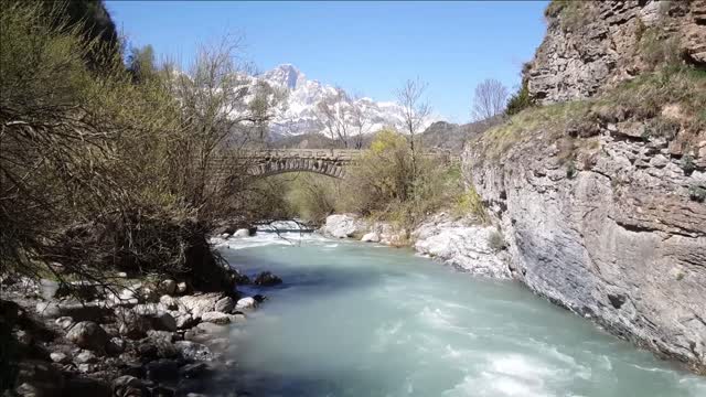 old stone bridge over a river around el pueyo de jaca in spain