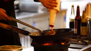 A Cook Using A Wok