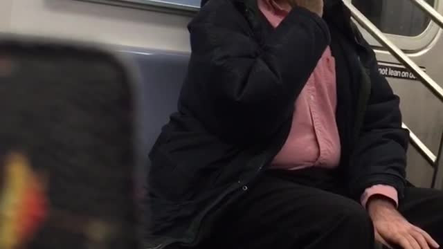 Man in red button up brushes teeth on subway