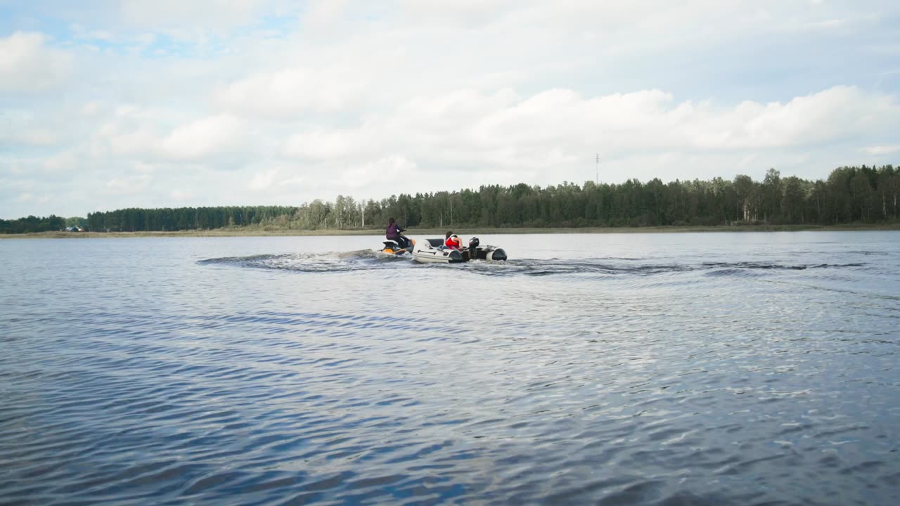 Motorboat and jet ski sailing on a lake