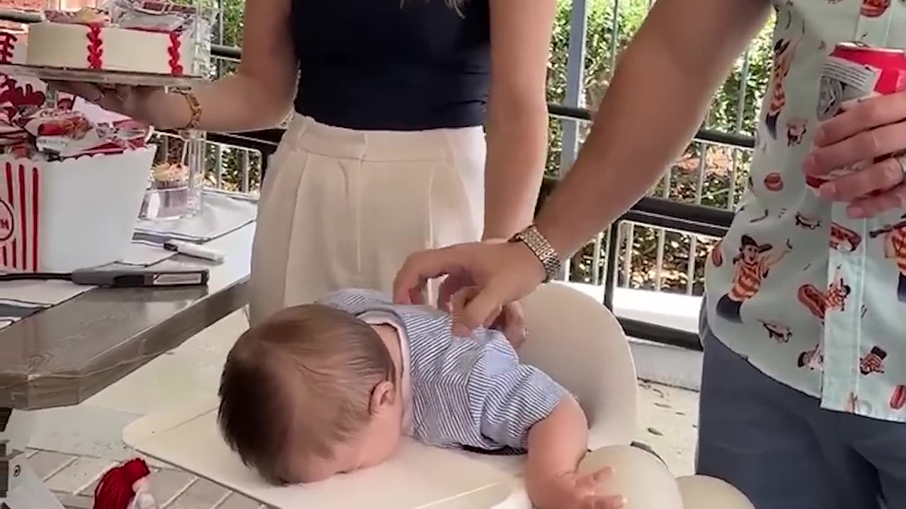 Adorable 1-year-old overwhelmed by family singing happy birthday