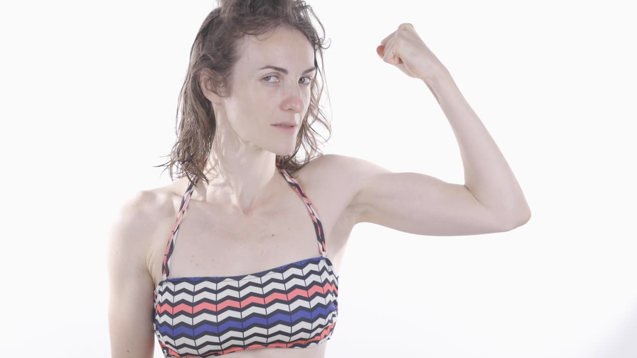 beautiful white girl showing her muscle