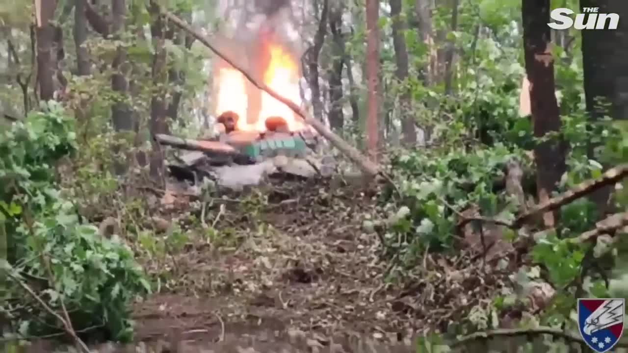 Russian tank blown to pieces burns as Ukrainian paratroopers watch on