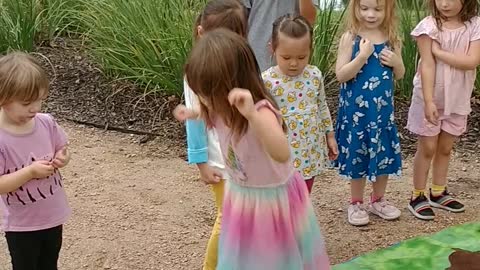 Houston mascot party character Peppa pig splashes muddy puddles at smooth stream park at birthday