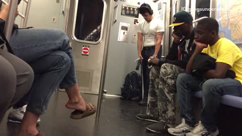 Man in white doing arm exercise on subway