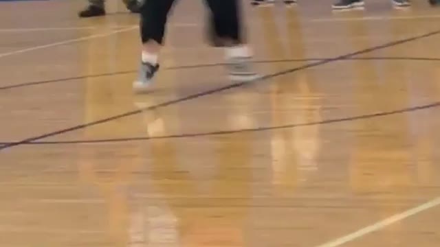 Girl in pink dances in basketball court