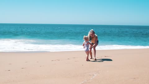 Adult and Child Having Fun at the Beach