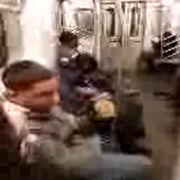 Guy with purple toothbrush on subway