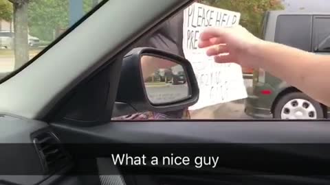 guy in car gives beer to homeless person on street