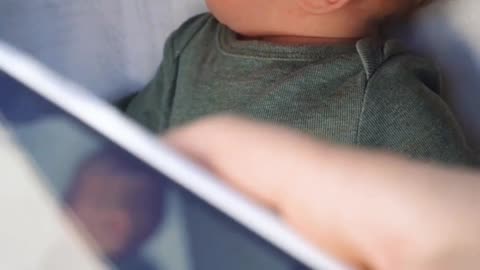 Person Taking a Picture of the Baby from the Phone