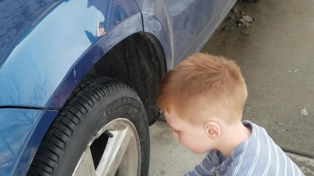 Boy explains how every work day starts. While trying to fix daddy's car