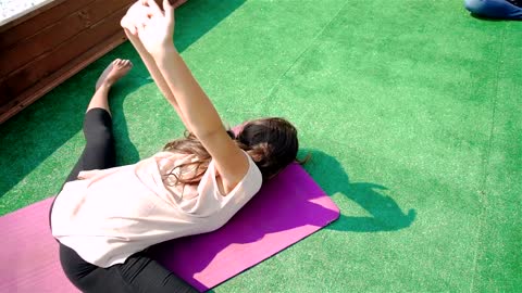 Young woman practicing a difficult yoga pose