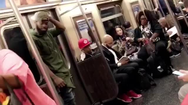 Man and woman dance perform on subway train