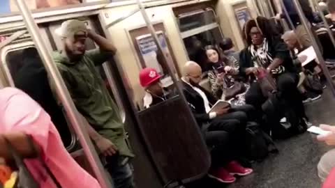 Man and woman dance perform on subway train