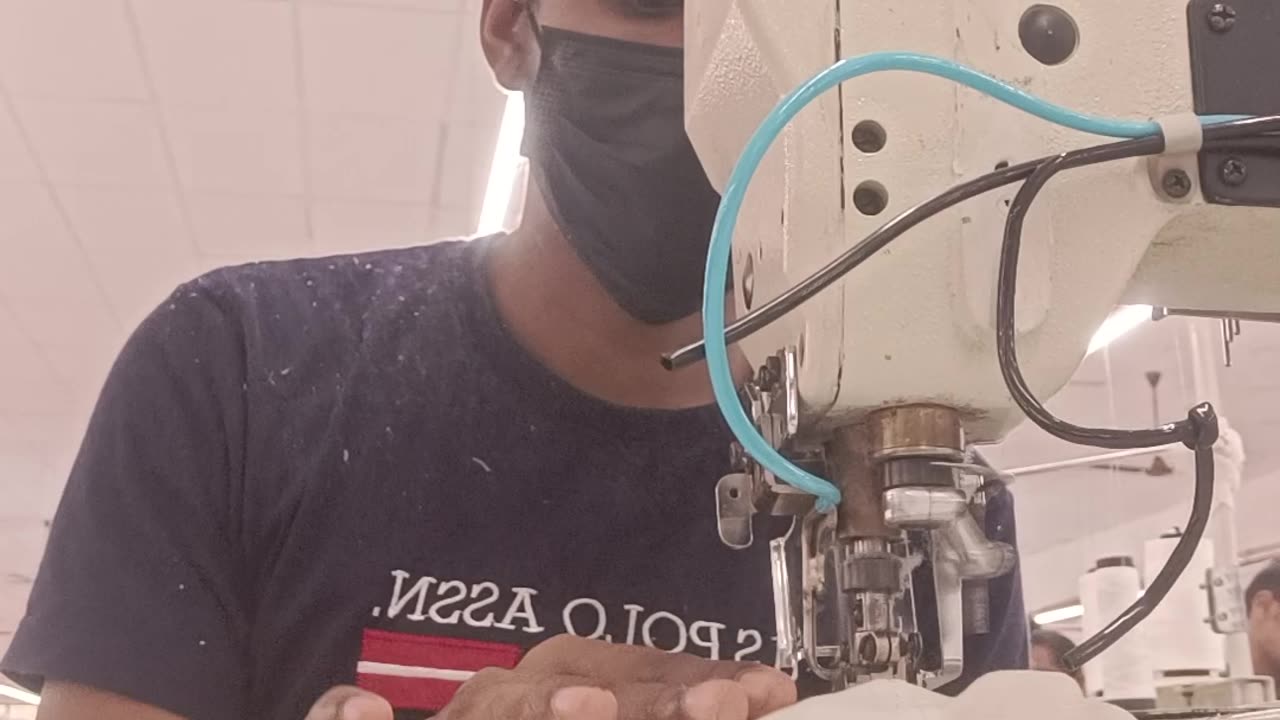 Sweater stitching machine in a factory.