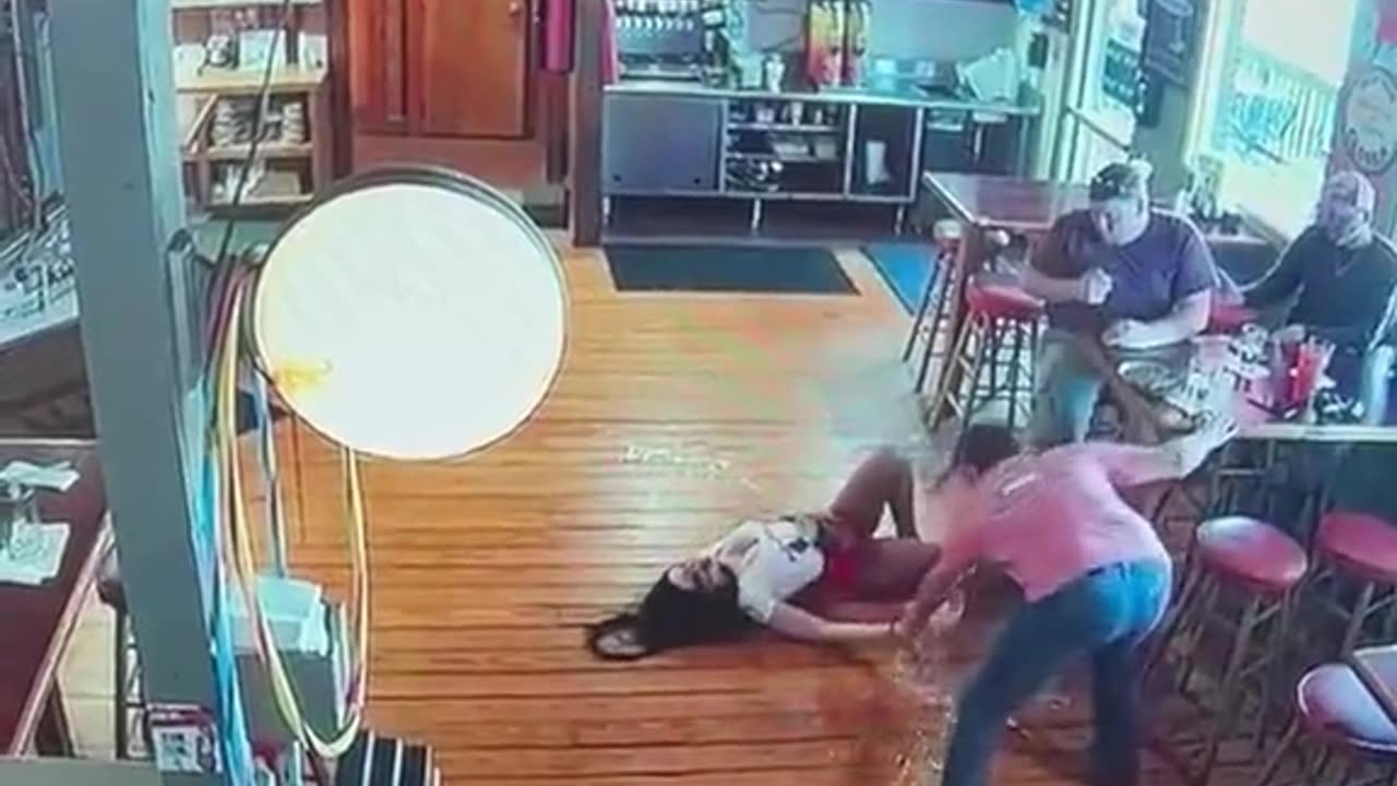 hot bar maid slips over with a jug of beer and does her best to save it.