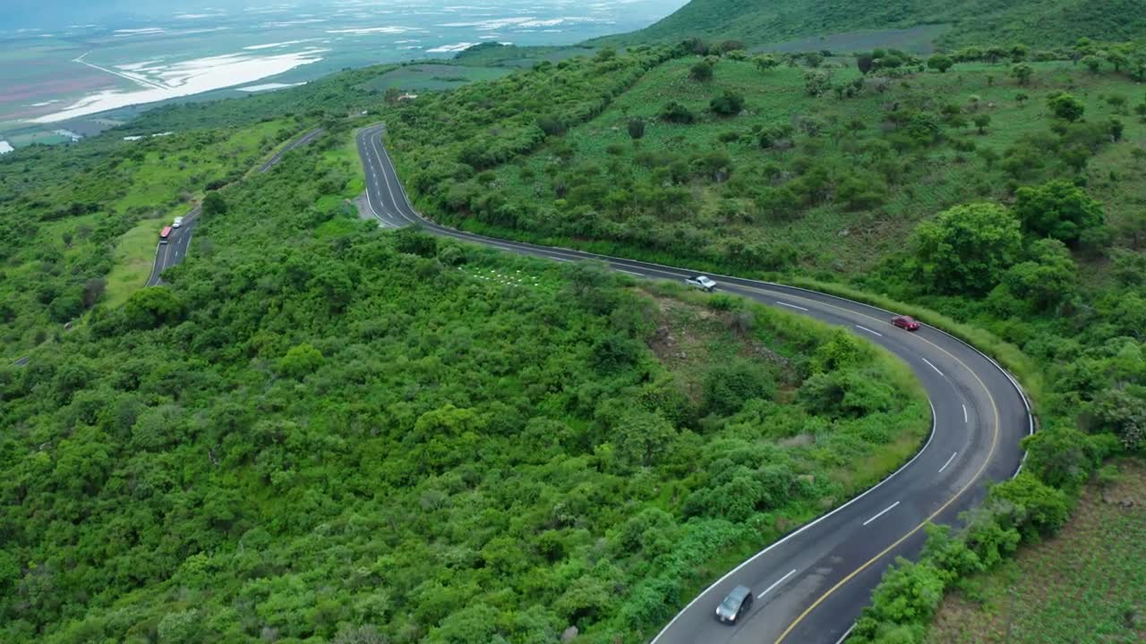 Curvy road on a tree covered hill