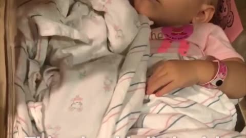 Little girl overprotective of newborn sister