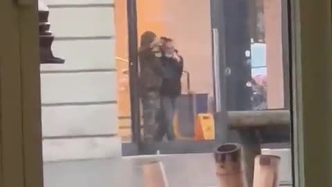 Footage from across the road shows the hostage taker waving a gun and holding someone in a headlock.