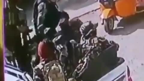 Taliban jumped out of a truck and slapped an Afghan wearing a former Afghanistan flag